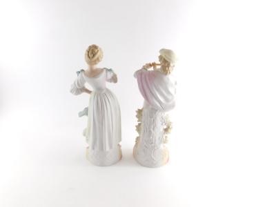 A pair of early 20thC Austrian bisque figures, of a lady and gentleman each dressed in finery, on scroll bases, 38cm high. - 2