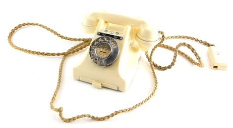 A vintage telephone, in ivory with front drawer and chrome mounts, the receiver attached by cord, 16cm high.