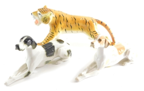 A USSR pottery recumbent dog, 27cm long, another and a tiger marked USSR. (3)