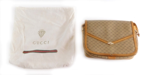 A Gucci clutch bag, in tan with outer pouch, 19cm wide.