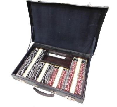 A case containing various opticians lenses, lens gauge, etc. (1 case)