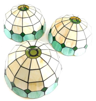 Three Tiffany style flower head shades, in green and cream, 20cm high. (3)