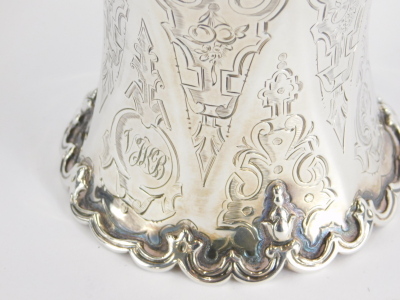 A Victorian silver christening mug, with scroll base and thumb mould handle, chased with scrolls and geometric pattern, London 1854, 11cm high, 4.3oz. - 2