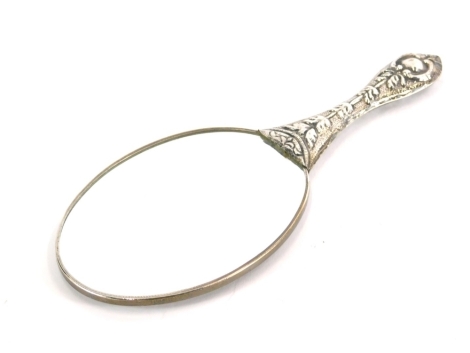 A 20thC hand mirror, heavily repousse decorated with flowers and scrolls, with plain bevel glass, 24cm long.