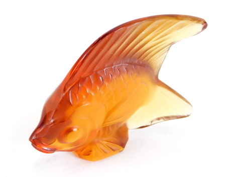 A 20thC Lalique amber coloured glass figure of a fish, signed France, 6cm high.