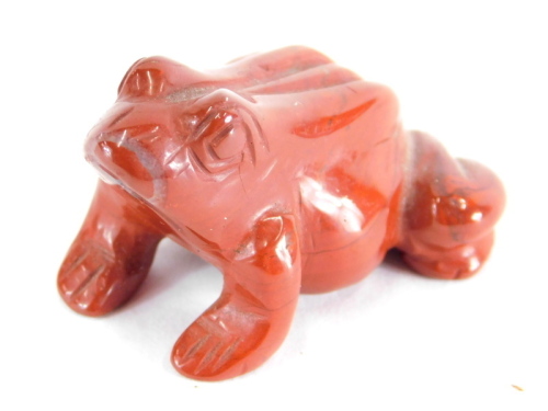 A 20thC polished brown glass figure of a frog, in the manner of Lalique, unsigned, 4cm wide.