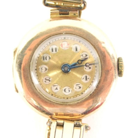 A 1950's 9ct gold cased wristwatch, the circular dial with numeric outer chapter ring and blue hands, with half Hunter type face, with seventeen jewel movement, on a gold plated bracelet, 23.1g all in.