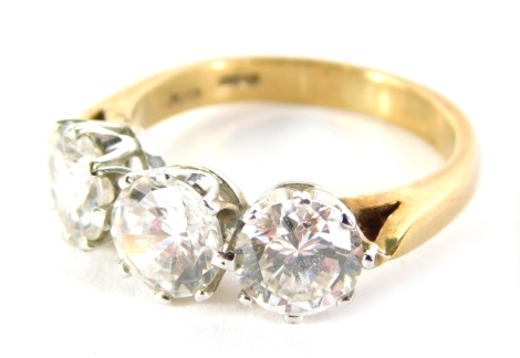 A CZ three stone ring, quartz set, on plain shank, size O.