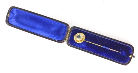 An Edwardian stick pin, with turned stem and claw set white glass top, 8cm high. (cased)