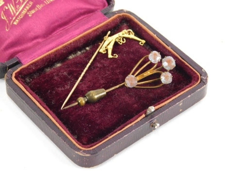 An Edwardian stick pin, with partial turned stem and unusual hanger style top, 8cm high, and another smaller. (2, 1 cased)