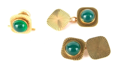 A pair of 9ct gold cufflinks, each square form with polished green centres, and a collar stud, 14g all in. (3)