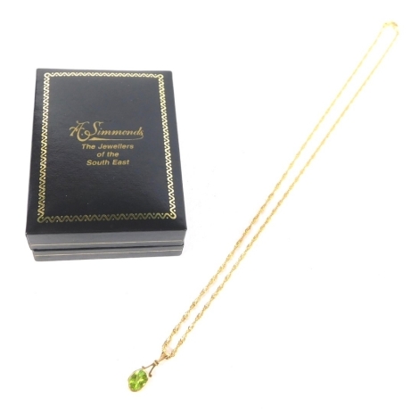 An Edwardian drop pendant, set with oval green stones, attached to a slender link necklace, 9k, 42cm long, 3g all in.