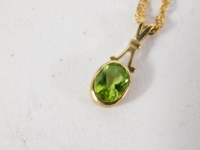 An Edwardian drop pendant, set with oval green stones, attached to a slender link necklace, 9k, 42cm long, 3g all in. - 2