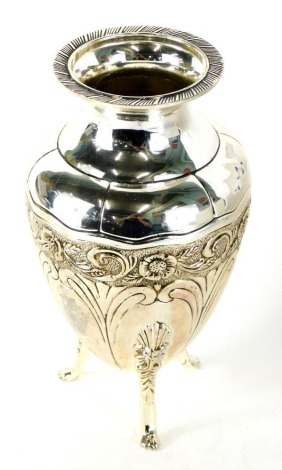 A 20thC silver plated vase, with compressed stem, repousse decorated with scrolls on paw feet etched with flowers, 20cm high.