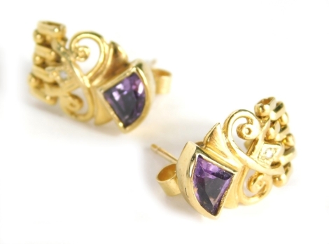 A pair of amethyst and diamond drop earrings, each with a triangle cut amethyst top, on scroll design basket, with graduated loose chain drop, set with tiny diamond in yellow metal marked 375, 2.5cm high, 3.3g all in.