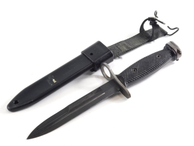 A 20thC Mio 8448476 dagger, with textured handle and scabbard, 29cm long.