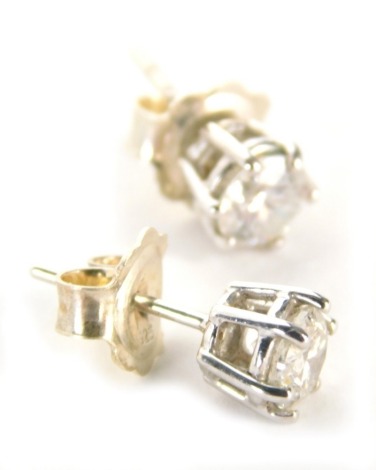 A pair of diamond stud earrings, each with a round brilliant cut diamond, in claw basket setting, 4.8mm x 4.8mm, on a white metal back unmarked believed to be 18ct gold, with silver backs marked 925, 1.7g all in.