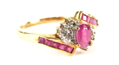 A 9ct gold cross over dress ring, set with pink and white claw set stones.