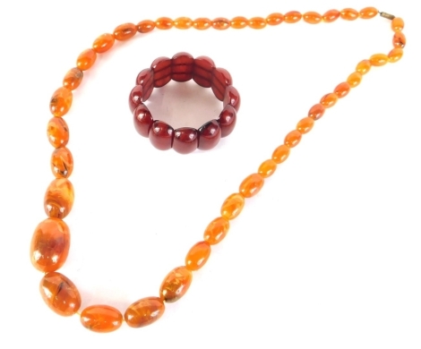 A graduated amber style bead necklace, 64cm long, and a polished cherry amber style bracelet (2),