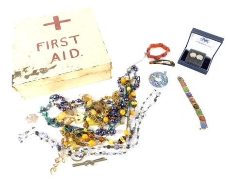 Various jewellery, a pair of threepenny bit cufflinks, various necklaces, amber style and others, brooch etc, in a first aid tin 22cm wide.