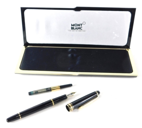 A Mont Blanc fountain pen, in black with gilt trim and arrow clip 14cm long with marked nib in fitted case with ink refill.