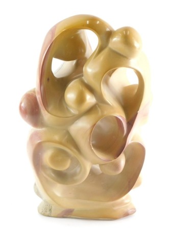 A heavily polished studio centrepiece, of scroll form in carved stone 35cm high