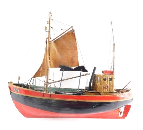 A 20thC wooden model of a boat, with realistic deck and rigging painted black and red 48cm long.