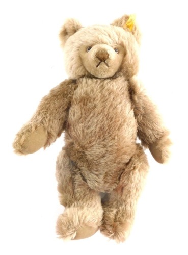 A modern Steiff Teddy bear, in brown with articulated limbs and button to the ear 38cm high.