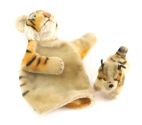 A 20thC tiger glove puppet, 16cm high and a toy dog with fixed limbs.(2)