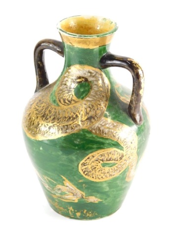 An unusual 19thC pottery two handled vase, hand painted with serpent on green ground, with R diamond mark beneath, numbered 1, 28cm high.