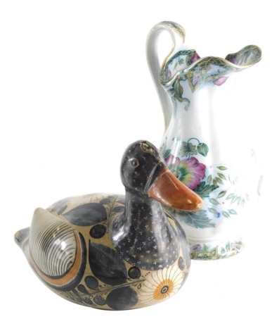 A South American pottery duck, decorated with flowers on a fawn ground marked beneath, 18cm high, and a Ceres Davenport press moulded and transfer printed jug.