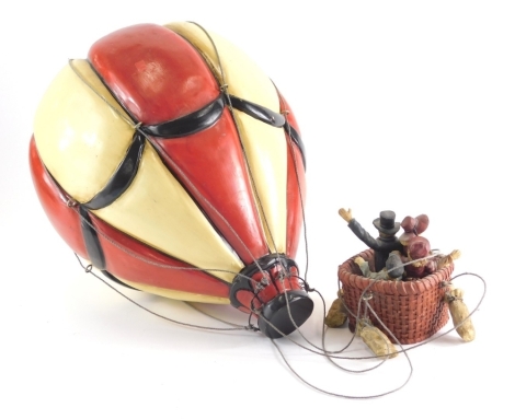 A decorative hand painted hot air balloon ornament, with hanging balloon and basket set with figures, 8cm high, etc.