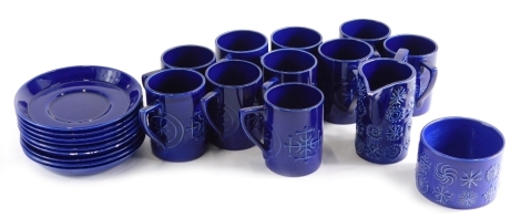 A Susan Williams-Ellis Portmeirion part service, in blue glaze comprising milk jug, 10cm high, sugar bowl, cups and saucers, printed marks beneath. (a quantity)