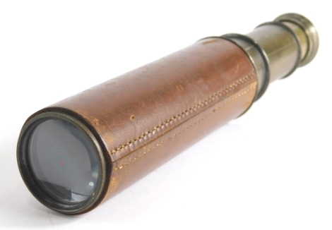 A 20thC Britannic Co three draw telescope with brown leather end, when closed 16cm long.