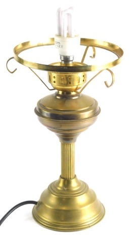 A 20thC brass oil lamp, with reeded column and electrical feature, 40cm high.