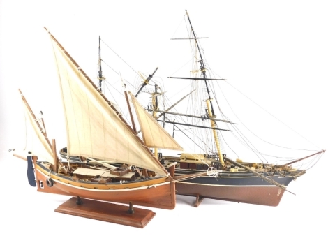 A 20thC model of a ship, with realistic mast and decking on a wooden plinth base, 46cm high and another. (2)