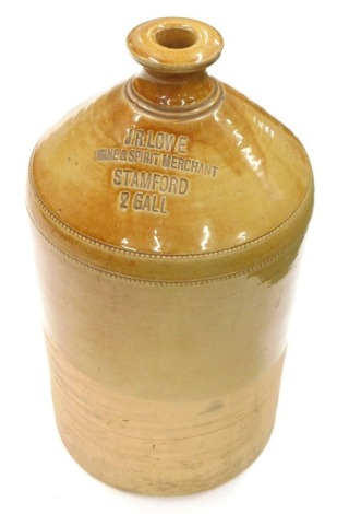 An early 20thC two coloured stoneware jar, impressed JR Lowe Wine and Spirit Merchants Stamford, stamped 2 gall, 44cm high.