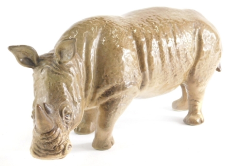 A 20thC Sylvac pottery figure of a rhinoceros, 5166 impressed and printed marks beneath, 13cm high.