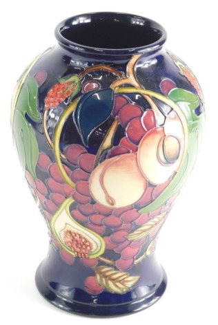 20thC Moorcroft Vase decorated with fruit and berries impressed and painted marks beneath, 26cm high.