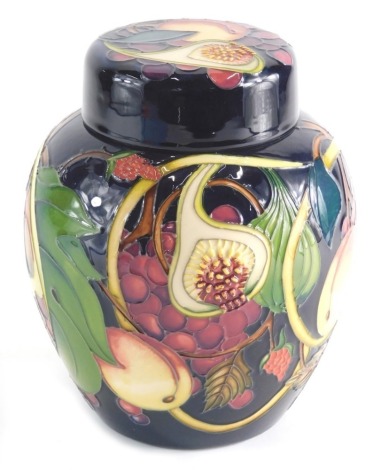 A 20thC Moorcroft Pottery Ginger Jar & Cover with fruit and flowers, pressed marks beneath, 24cm high.