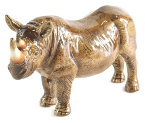 A John Beswick figure of a rhinoceros, signature mark beneath, 11cm high.