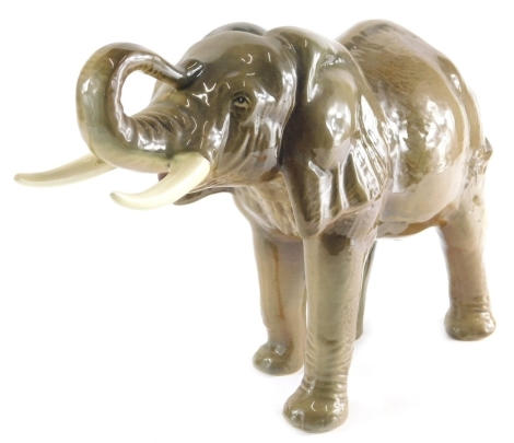 A 20thC Sylvac pottery figure of an elephant, trunk raised, printed marks beneath, 26cm high.