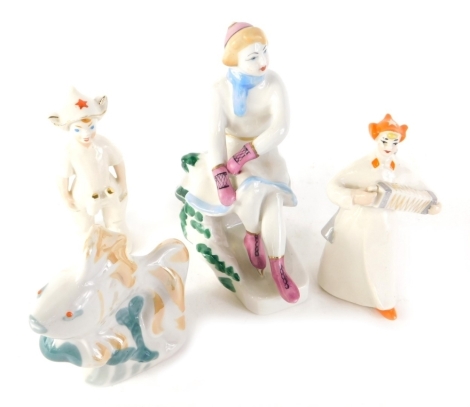 Four 20thC Ukrainian porcelain figures, to include girl playing squeeze box wearing orange hat, 12cm high, various marks beneath. (4)