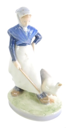 A Royal Copenhagen figure of a lady aside goose, number 528, marked beneath, 20cm high.