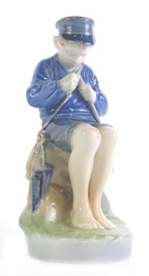 A Royal Copenhagen figure of a seated child, number 905, marked beneath, 19cm high.