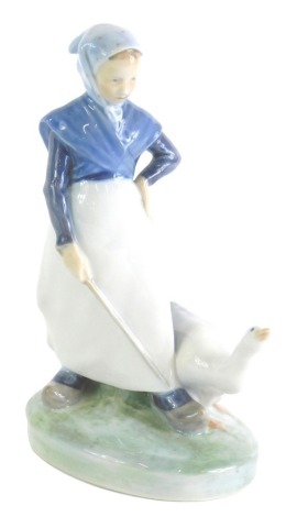 A Royal Copenhagen figure of a lady aside goose, number 067, marked beneath, 20cm high.