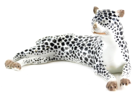 A Meissen style porcelain figure, of a recumbent wild cat, unmarked, 12cm wide