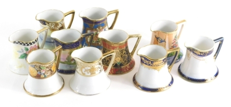 Various 20thC Noritake porcelain jugs, to include some hand painted and gilt highlight 8cm high etc. (a quantity)