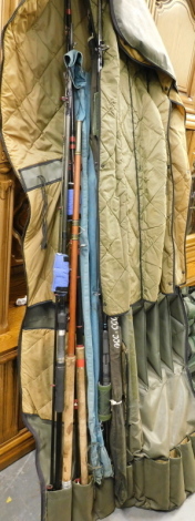 A collection of fishing rods and a rod holdall, including a Silstar 3553-330, two fibre glass rods, etc.