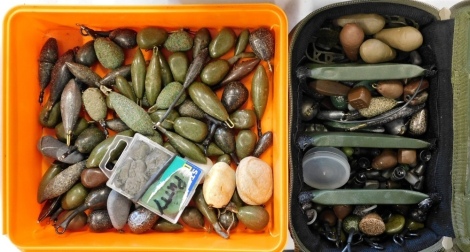 A Wychwood fishing case and a collection of weights, (some loose).